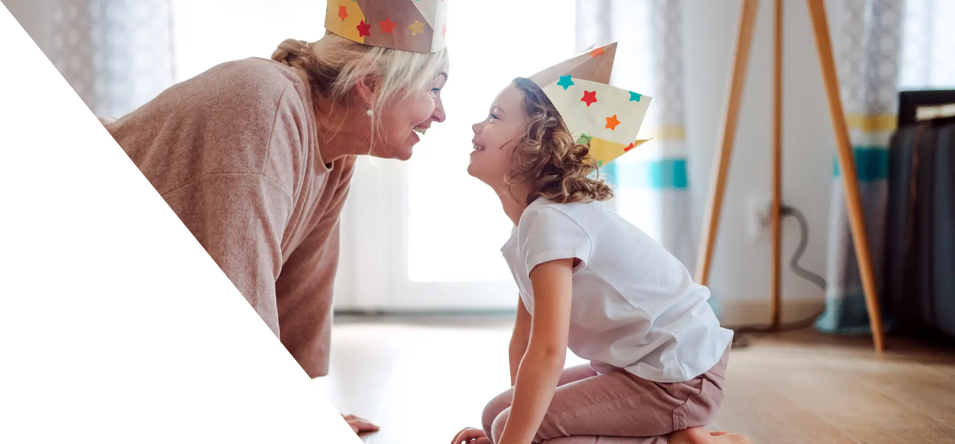 there is a woman and a child wearing party hats on the floor
