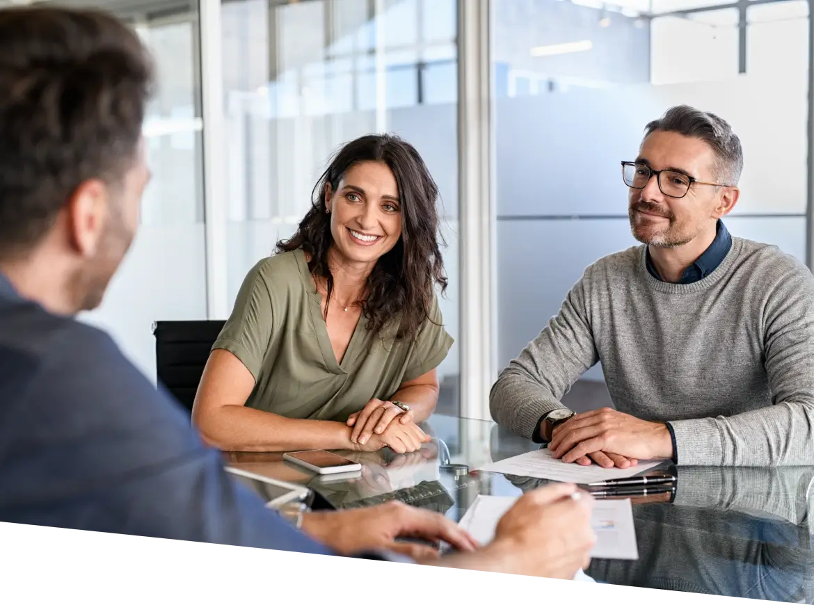 man and woman sitting at a table with papers 